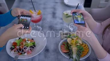 减肥食品，智能手机上的女朋友在健康期间为社交媒体拍照蔬菜和水果沙拉